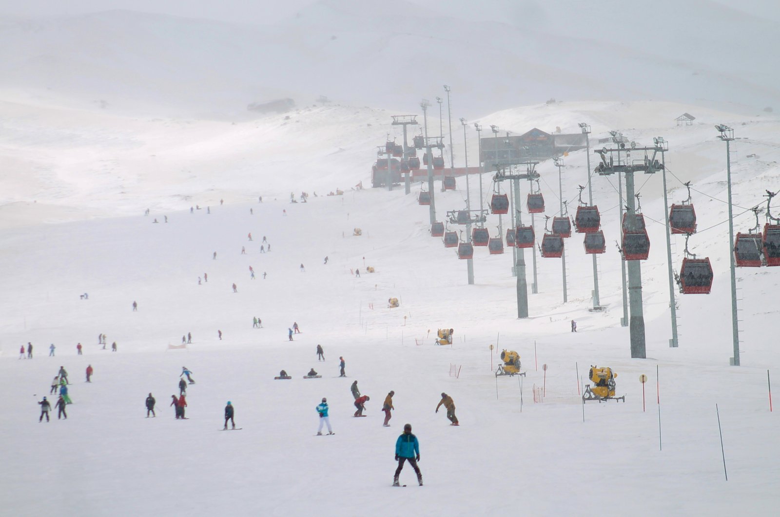 Ercİyes Ski Resort in Turkey - a group of people skiing down a snowy hill.