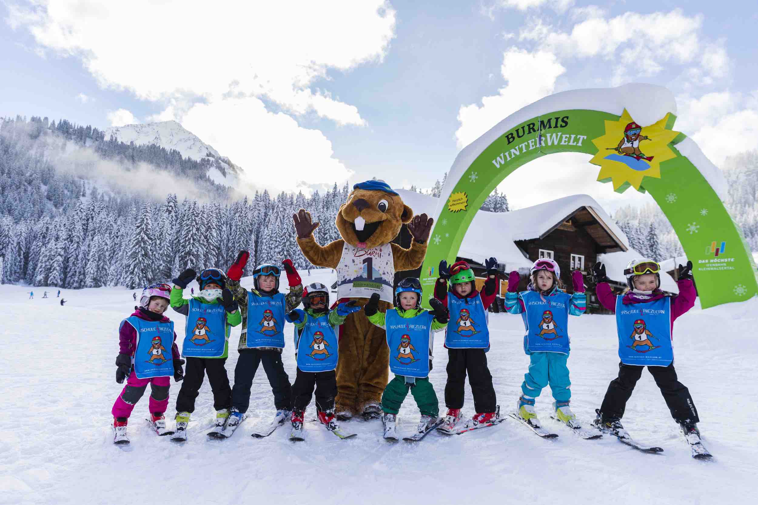 Winter sports enthusiasts enjoy a day on the slopes of Walmendingerhorn-Heuberg ski resort in Bregenz, Austria. A quaint chalet is nestled amongst the snowy landscape.