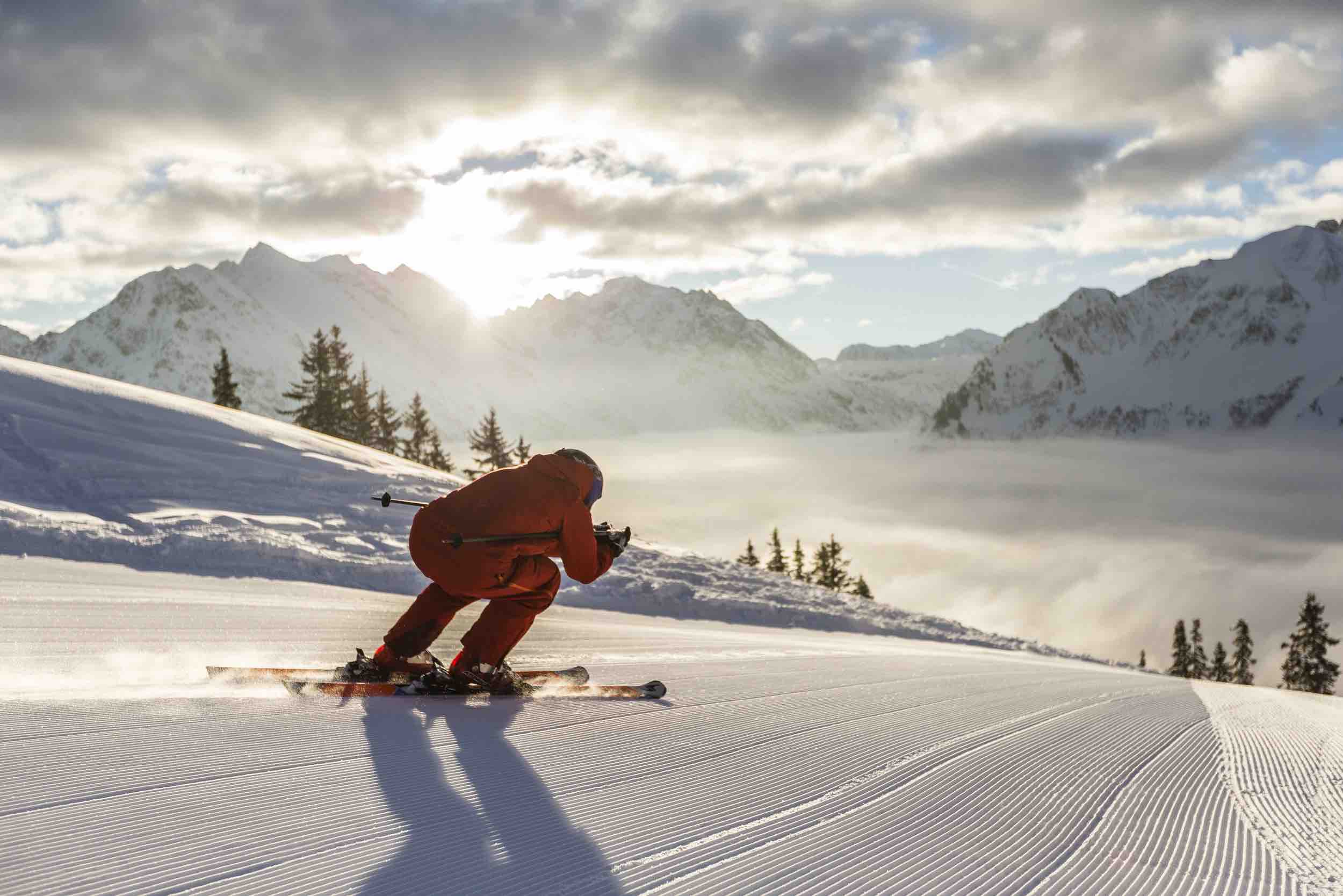 A skier and a snowboarder enjoying a sunny day on the slopes of Walmendingerhorn | ​Heuberg – Mittelberg | ​Hirschegg, a charming ski resort in Bregenz, Vorarlberg, Austria.