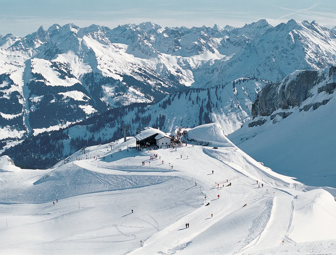 Walmendingerhorn | Heuberg – Mittelberg | Hirschegg in Austria - a group of people skiing down a snowy mountain.