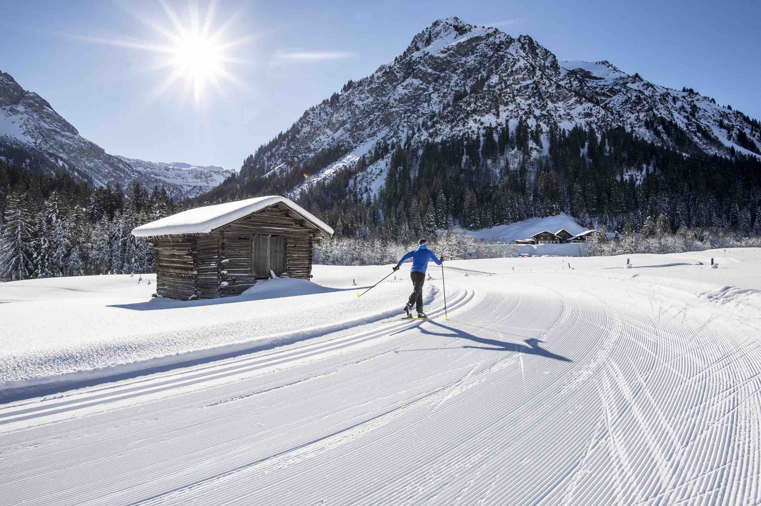 A vivid winter sports scene at Walmendingerhorn | Heuberg – Mittelberg | Hirschegg in Bregenz Austria complete with skiers enjoying the snow-covered slopes surrounded by a well-equipped ski resort.