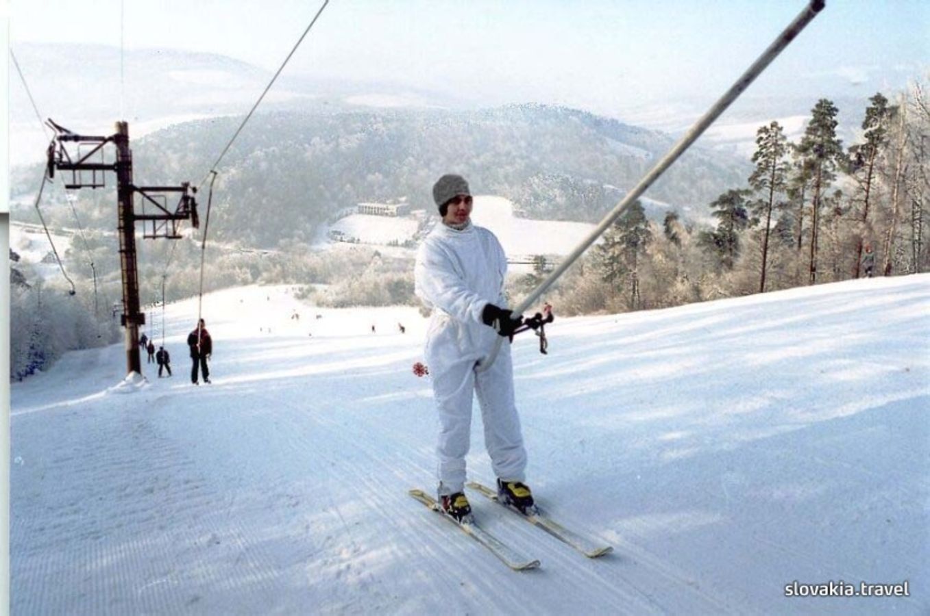 Makovica – Nižná Polianka in Slovakia - a man in a white suit skiing down a hill.