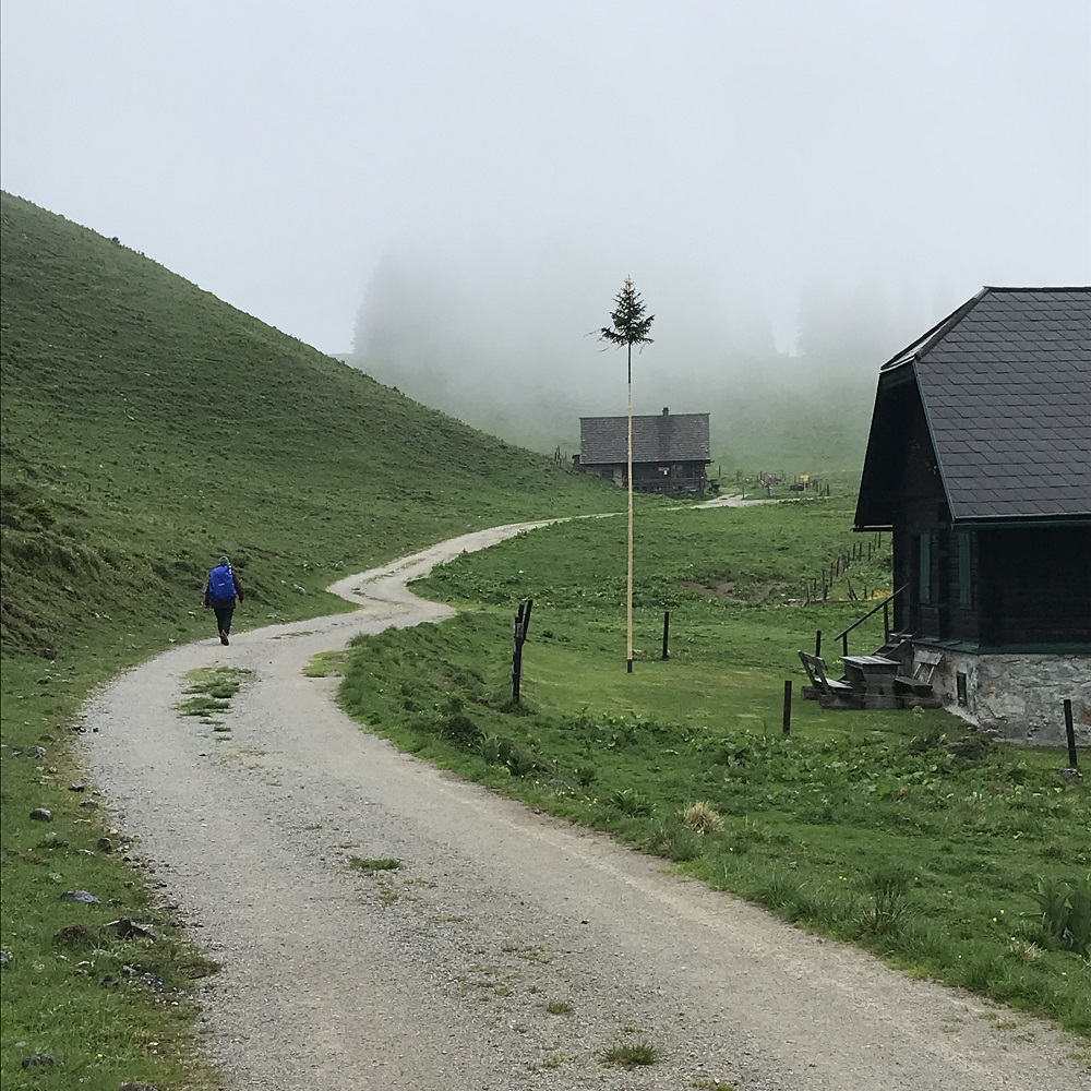 Schanz – Fischbach in Austria - a man walking down a dirt road in the mountains.