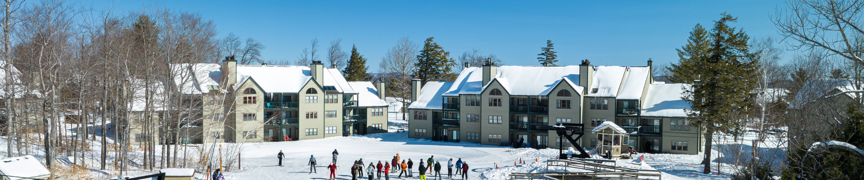 Okemo Mountain Resort in USA - a group of people skiing down a hill.