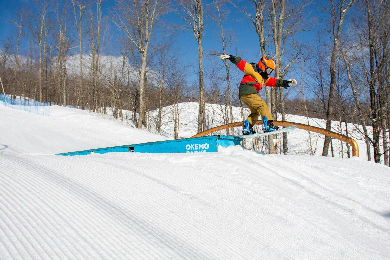 Okemo Mountain Resort in USA - a person on a snowboard doing a trick.