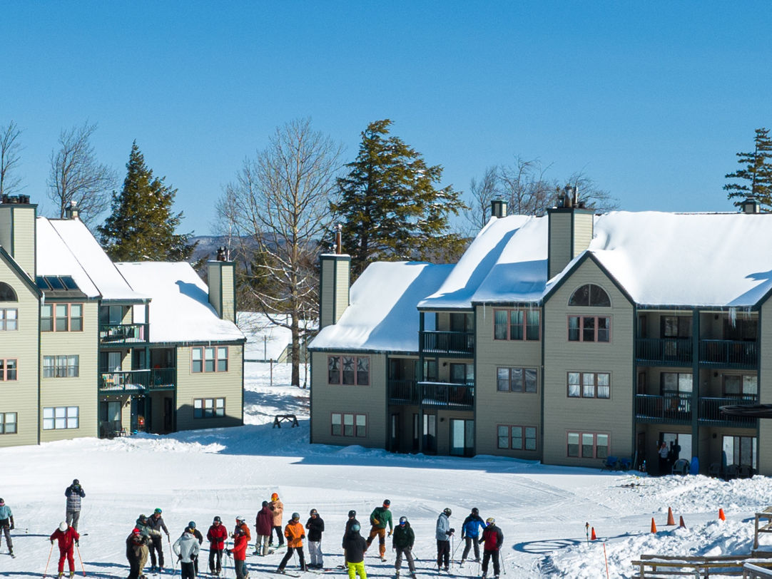 Okemo Mountain Resort in USA - a group of people skiing down a hill.