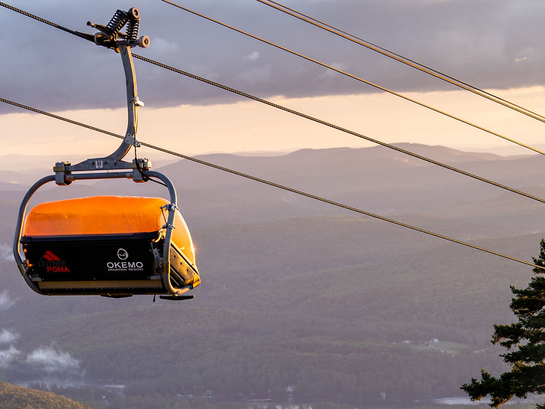 Okemo Mountain Resort in USA - a ski lift going up a mountain.