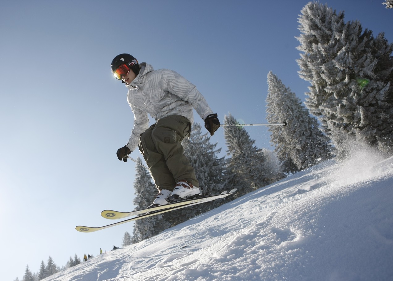 Rohrhardsberg – Schonach in Germany - a man riding a snowboard down a snow covered slope.