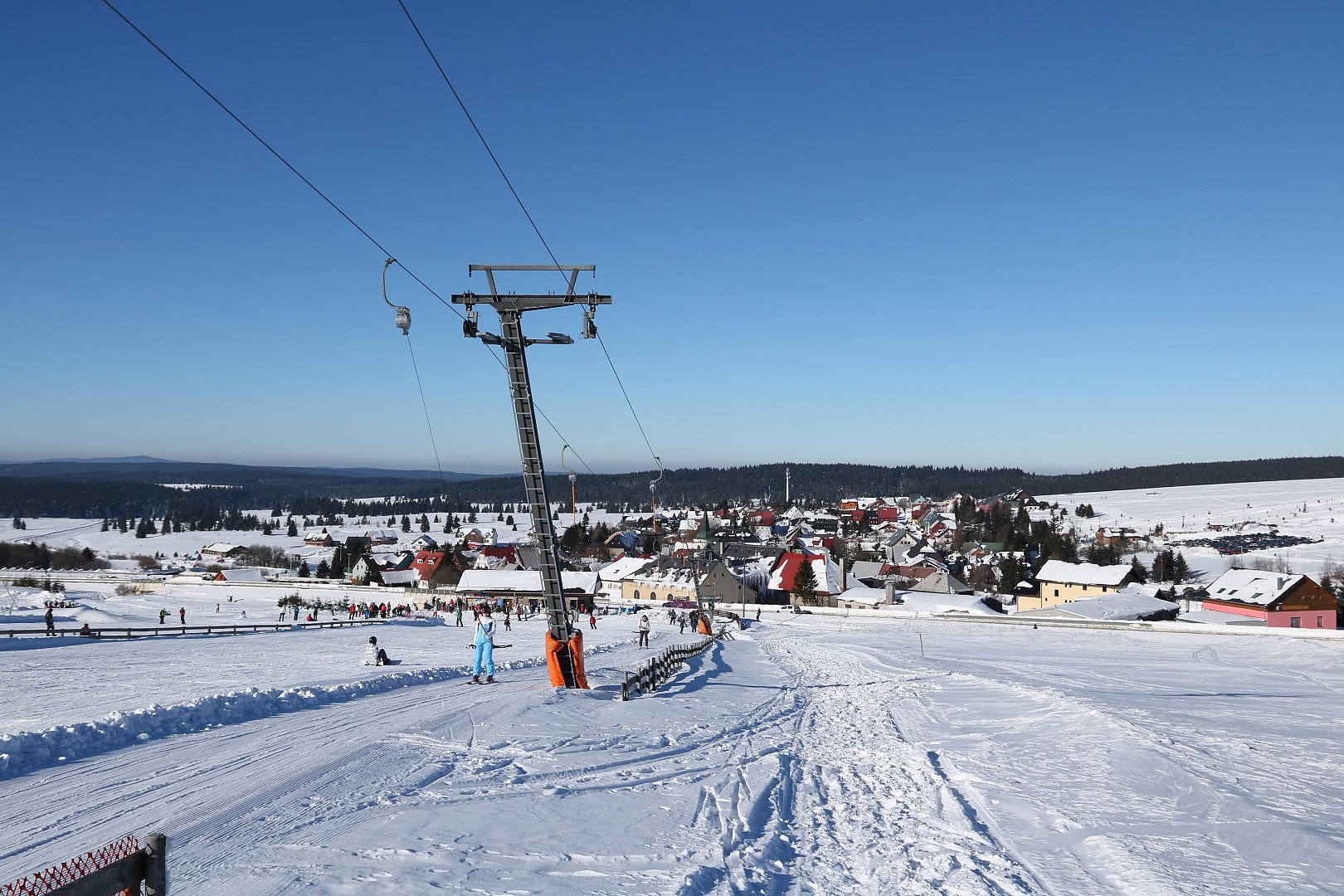 Hranice – Boží Dar in Czech Republic - a group of people riding ski boards down a hill.