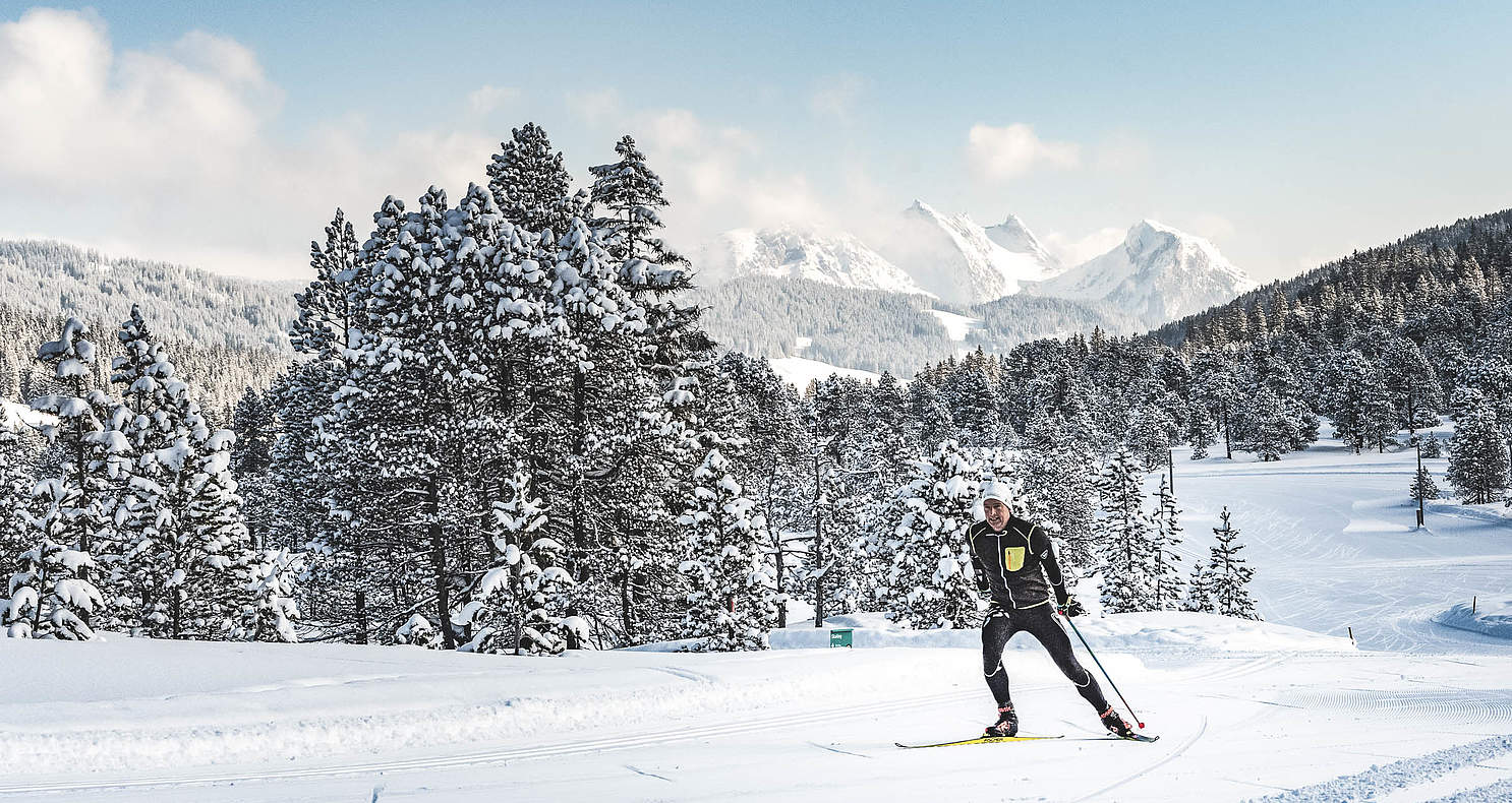 Langis in Switzerland - a person on skis on a snowy slope.