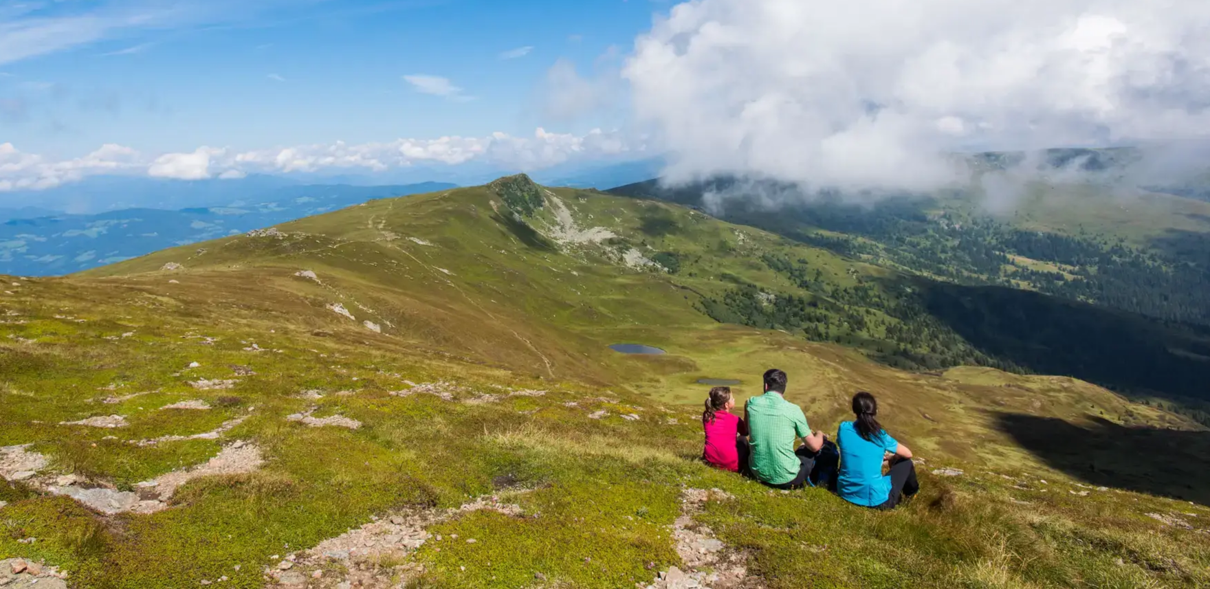 Saualpe – Eberstein in Austria - two people sitting on top of a mountain.