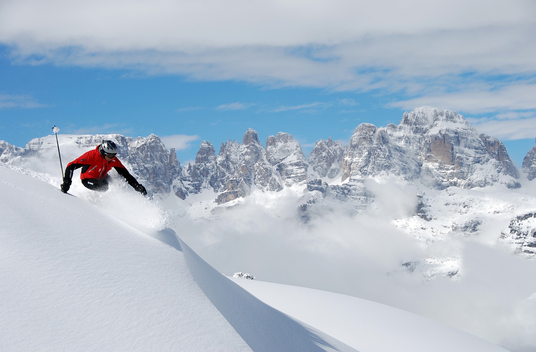 Paganella – Andalo in Italy - a person on a snowboard on a snowy slope.