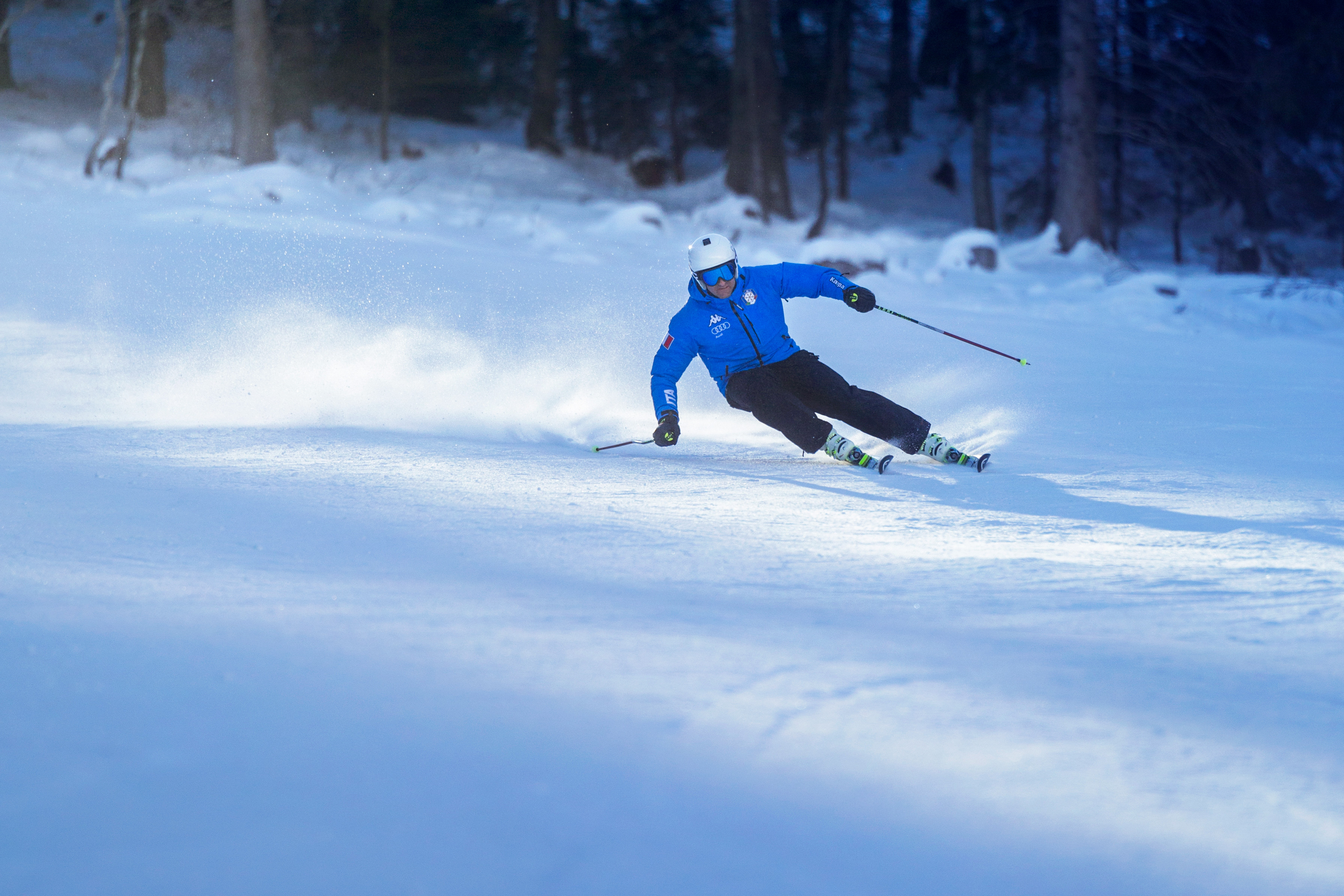 Paganella – Andalo in Italy - a man in a blue jacket skiing down a hill.