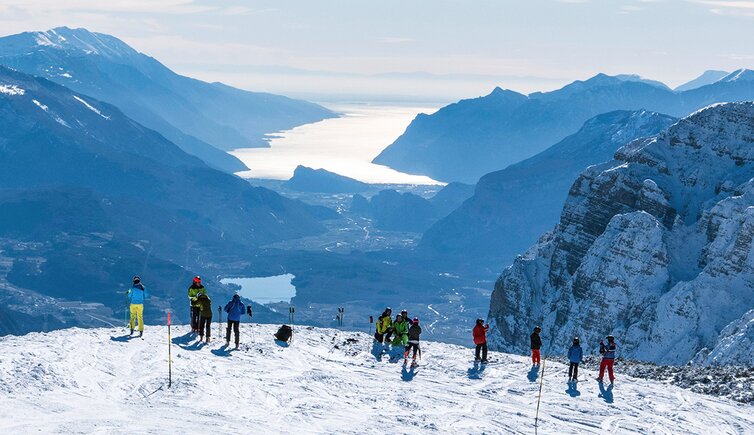 Paganella – Andalo in Italy - a group of people standing on top of a mountain.
