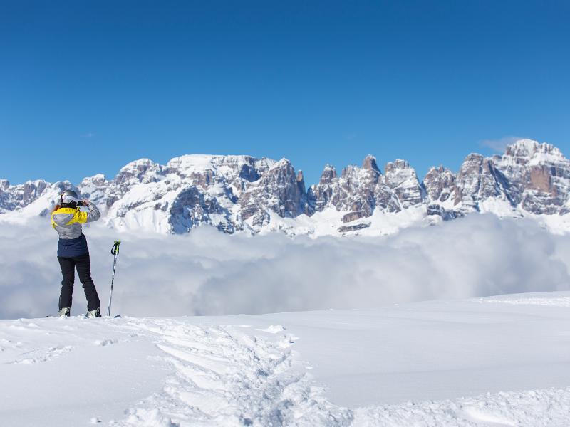 Paganella – Andalo in Italy - a person standing on top of a snow covered mountain.