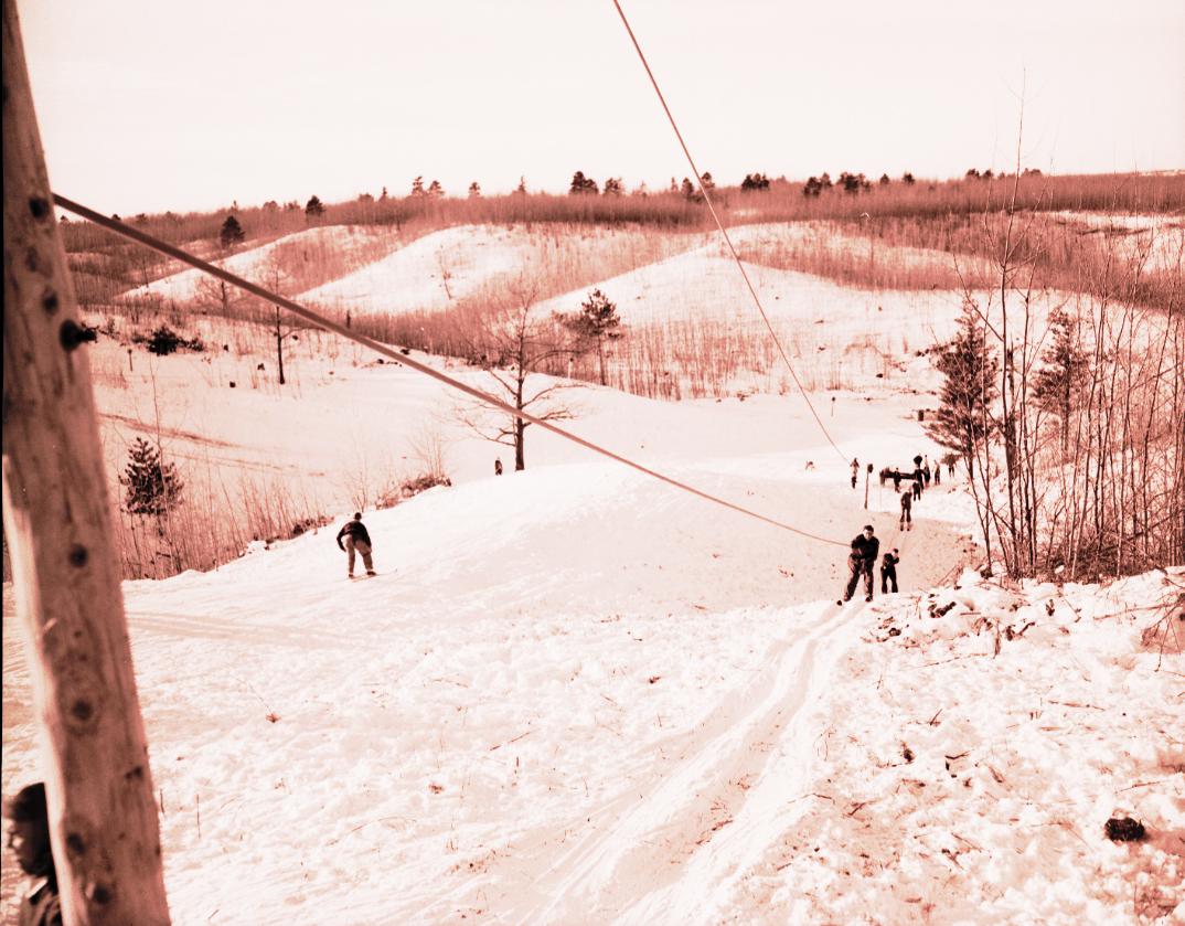 Missaukee Mountain in USA - a group of people walking down a snow covered hill.