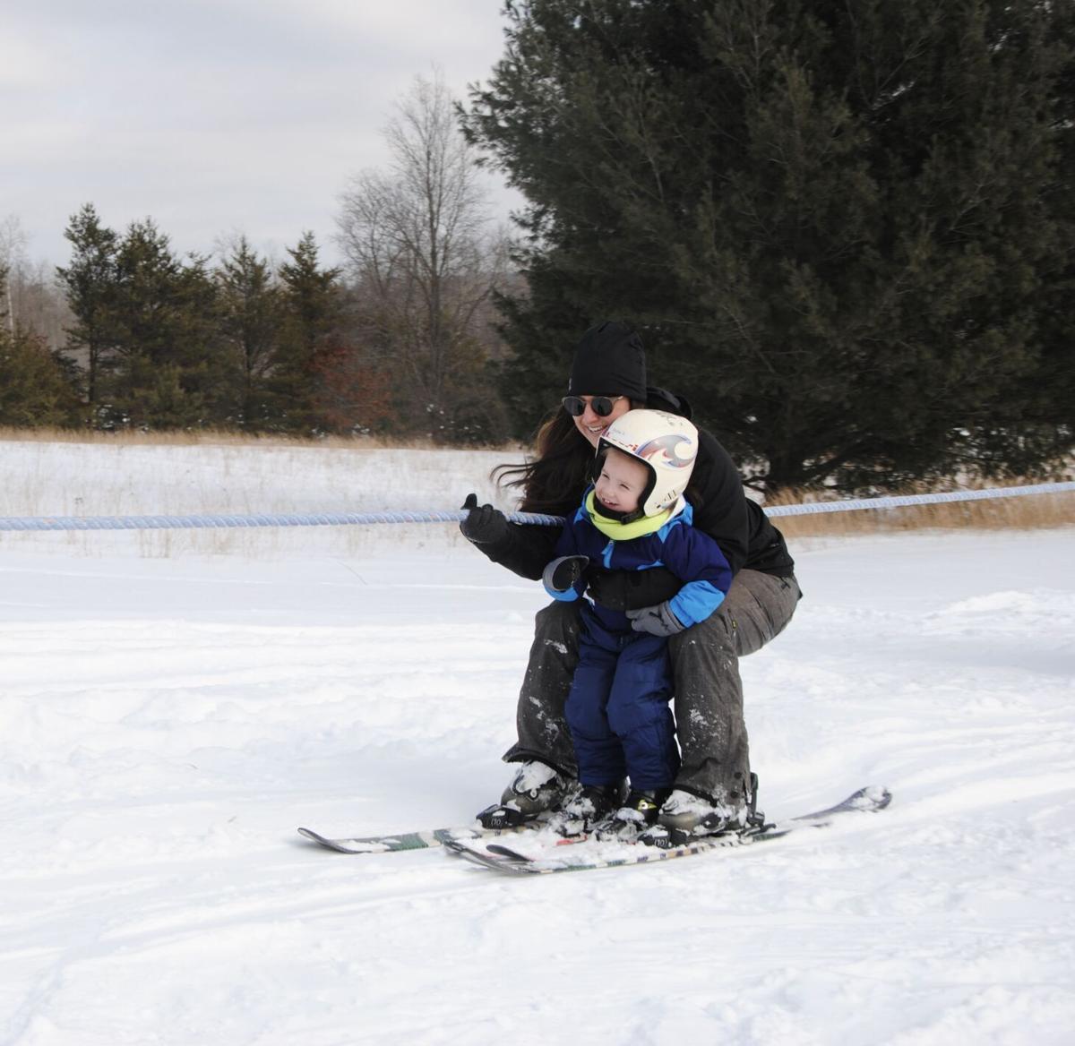 Missaukee Mountain in USA - a small child on a snowboard.