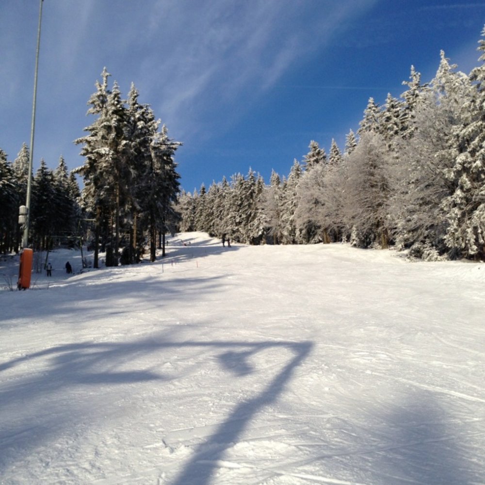 Přimda in Czech Republic - a snow covered ski slope with trees in the background.