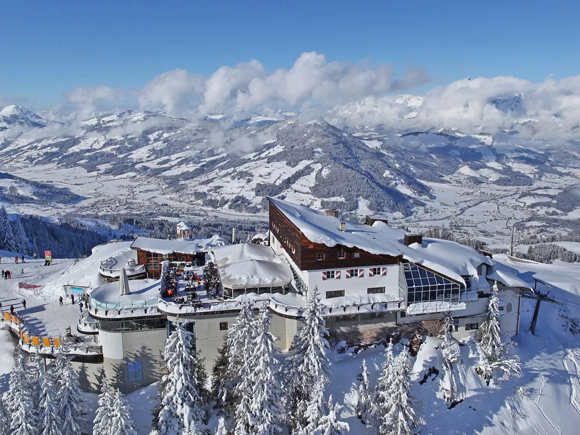 Schatzerlift – Kirchberg in Austria: a ski resort surrounded by snow covered trees.