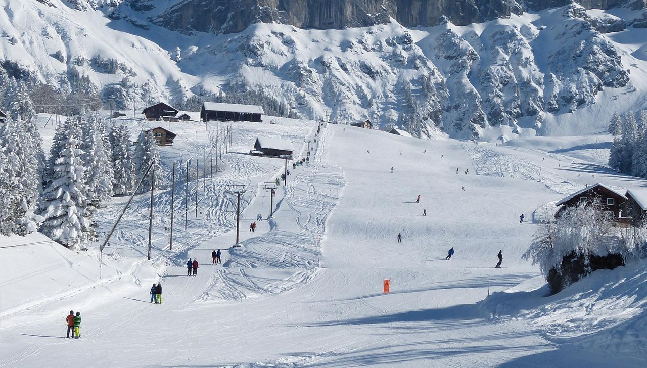 Kellerberg – Haldi in Switzerland - a group of people skiing down a snowy slope.