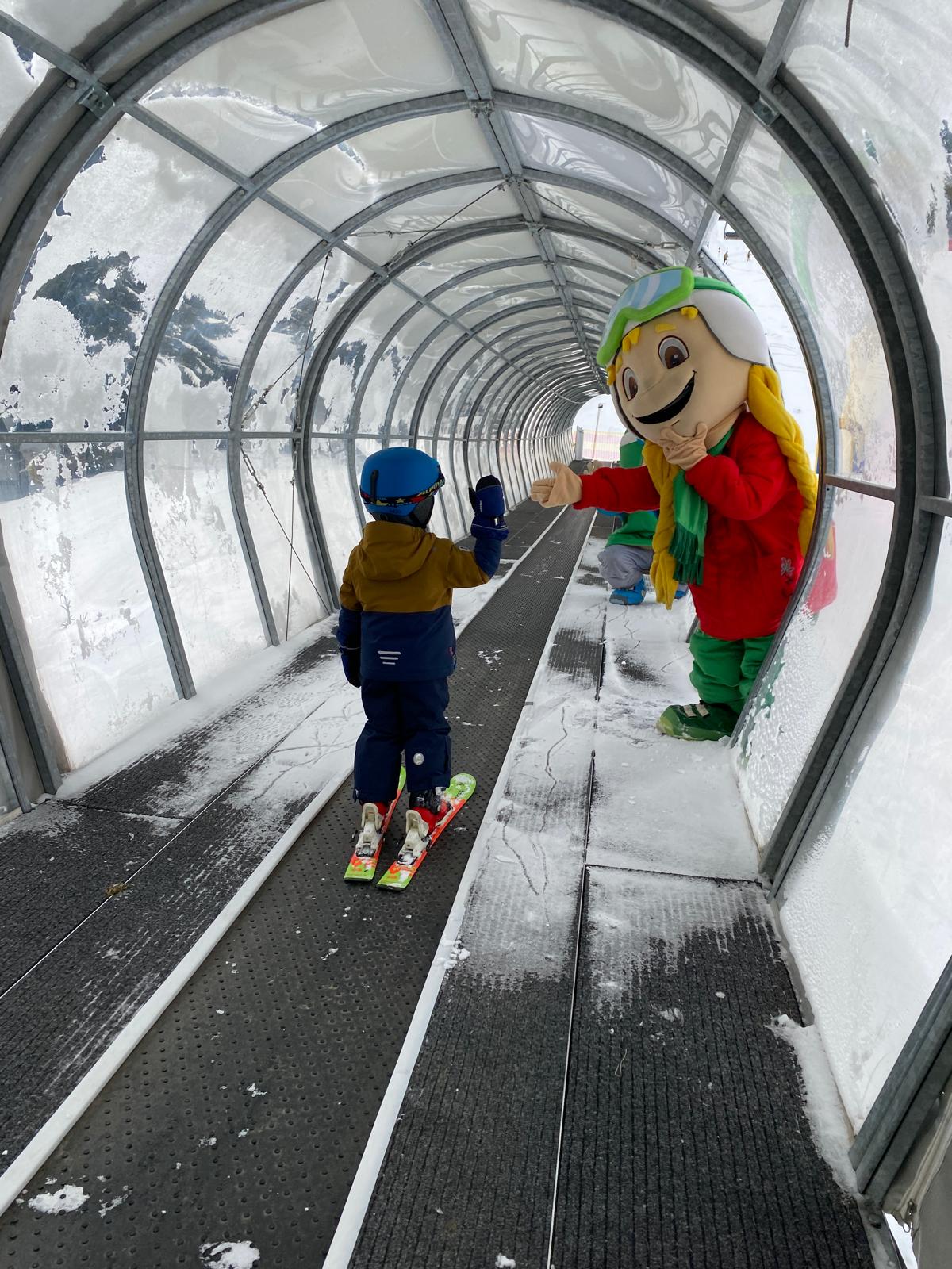 Muttereralm in Austria - a couple of people riding down a snow covered tunnel.