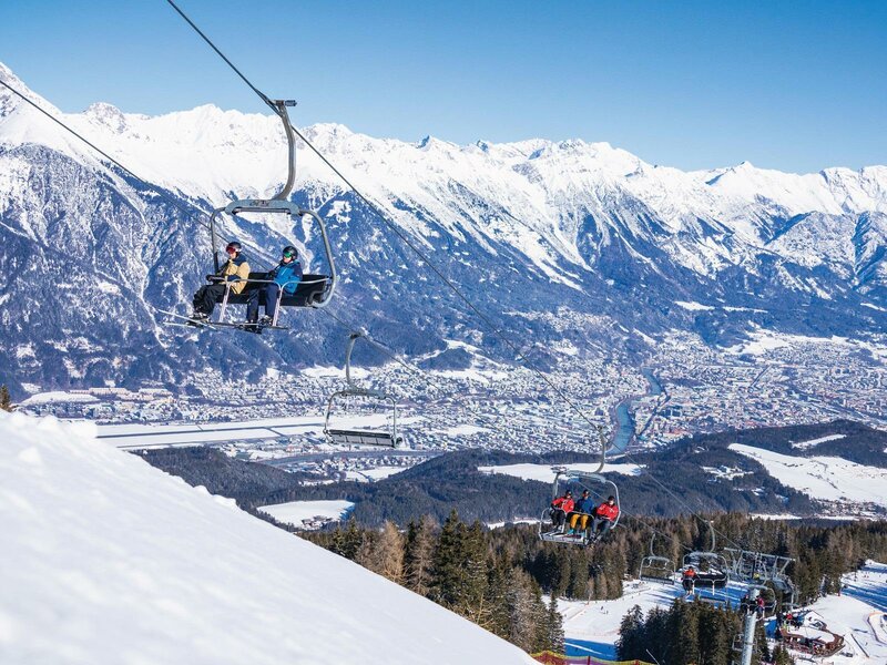 Muttereralm in Austria - a person on a ski lift in the mountains.
