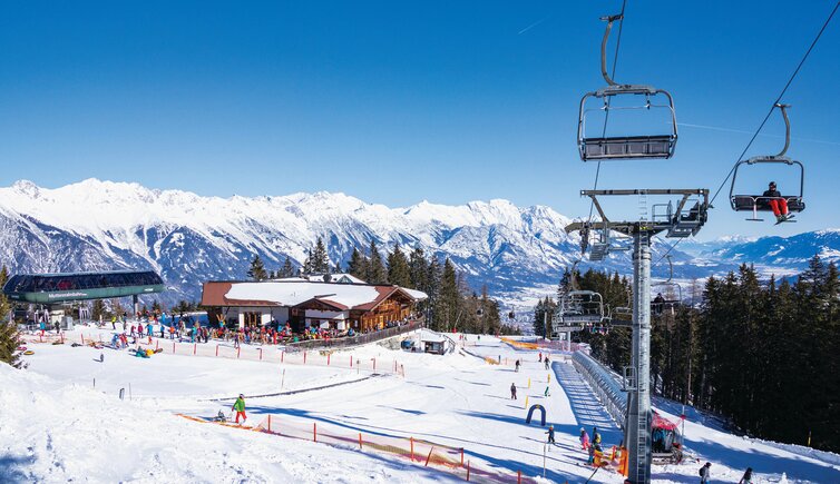 Muttereralm in Austria - a ski slope with a ski lift in the background.