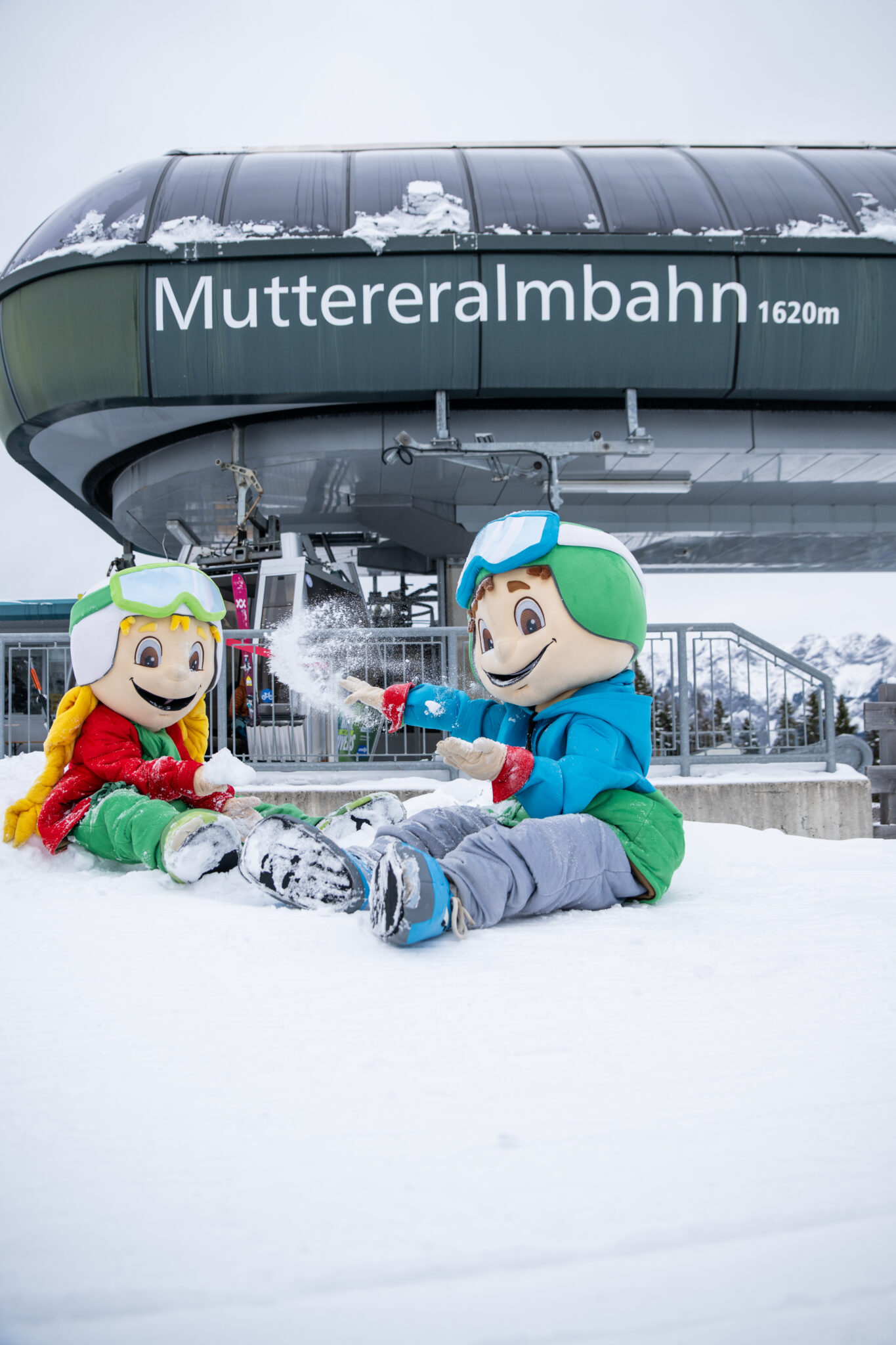 Muttereralm in Austria - a couple of people sitting in the snow.