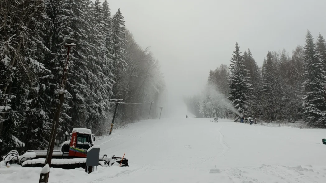 Pradědova aréna in Czech Republic - a snow covered ski slope with trees in the background.