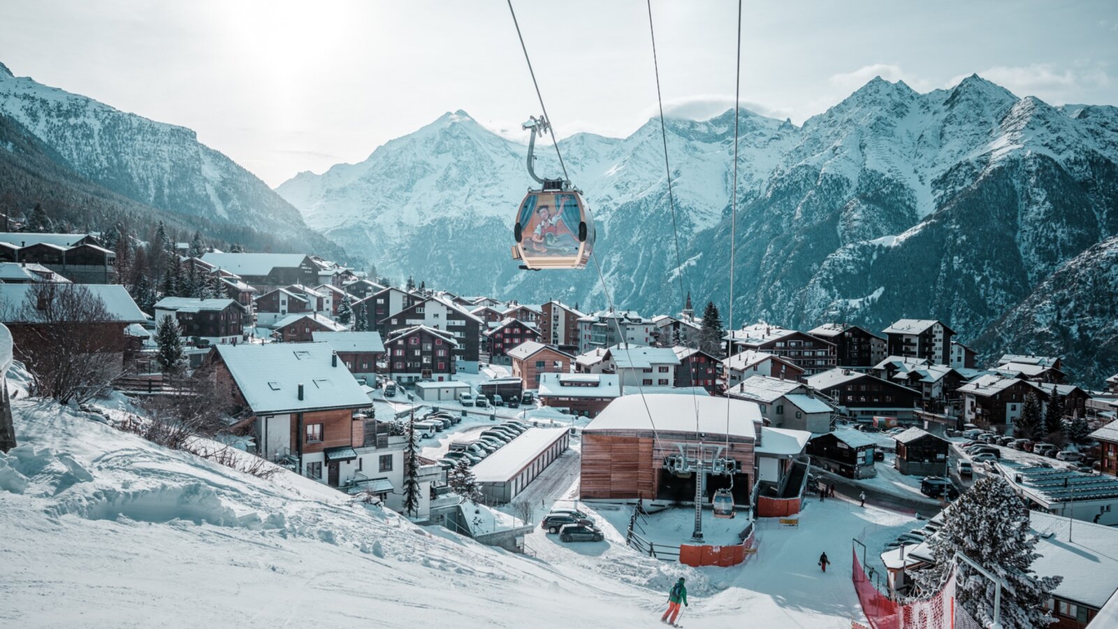 Grächen in Switzerland - a ski lift in the middle of a snowy town.