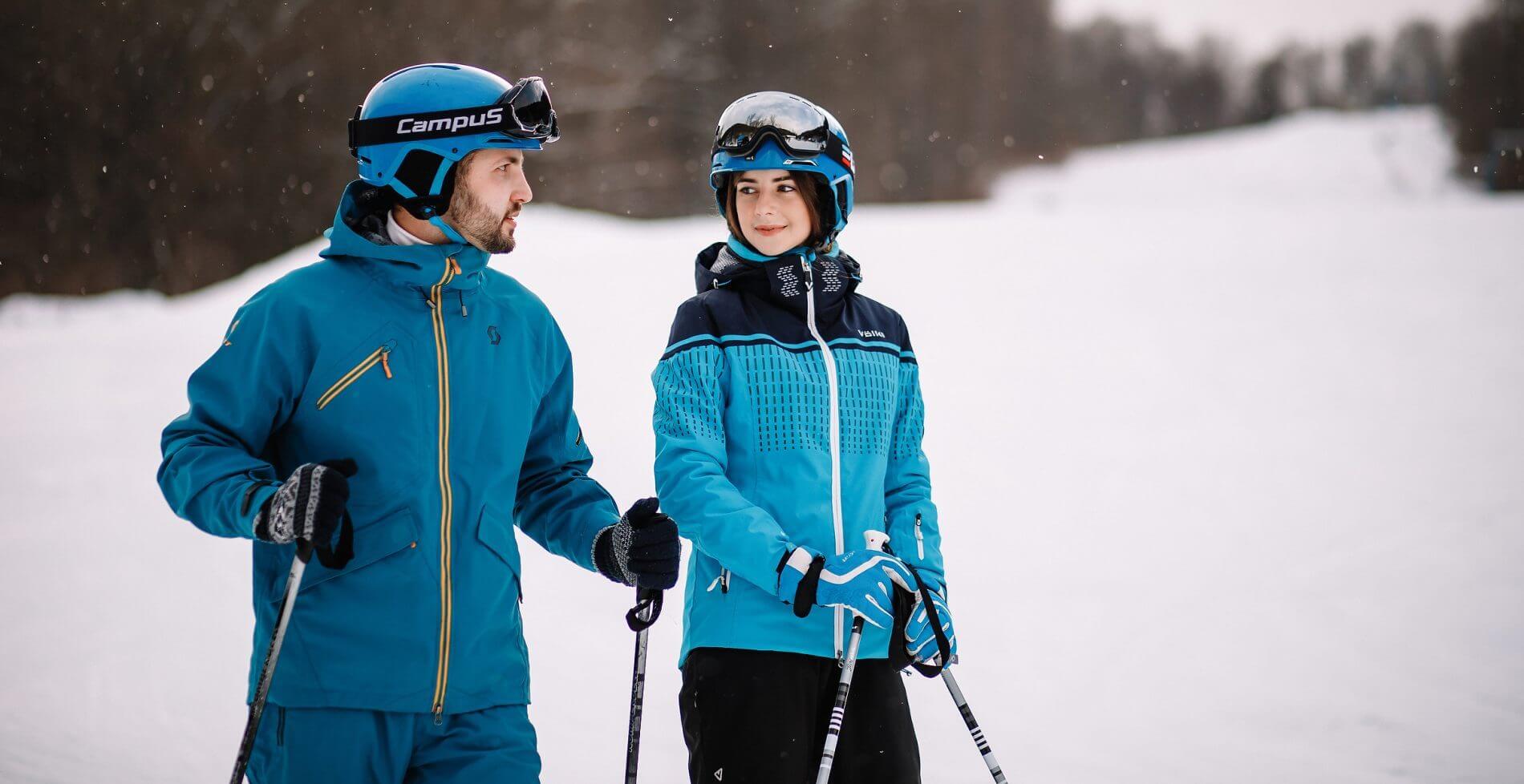 Voevodyno in Ukraine - two people standing in the snow holding ski poles.