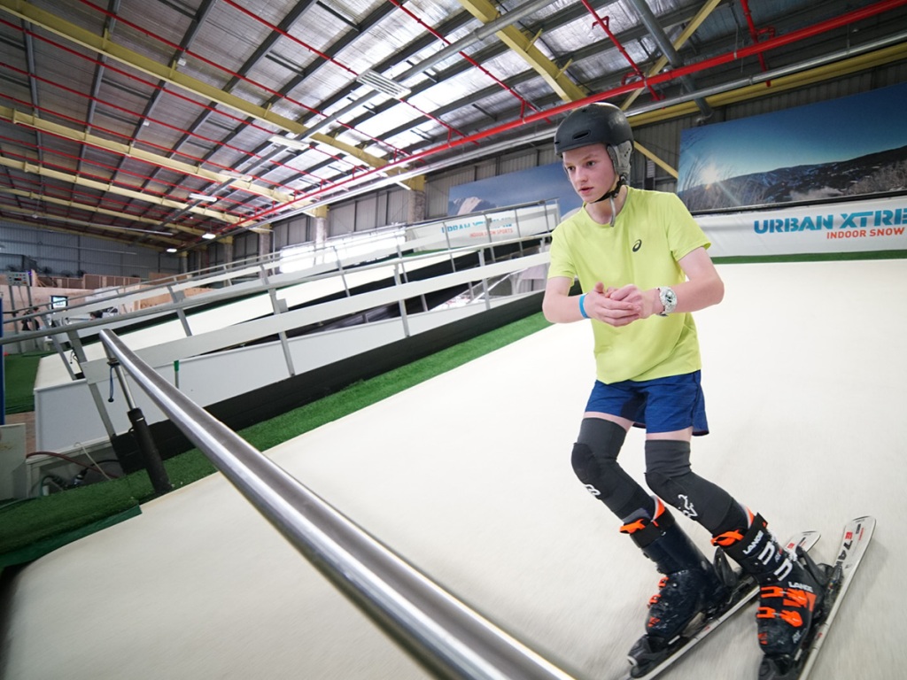 Ski parque in Portugal - a young boy riding a skateboard down a ramp.