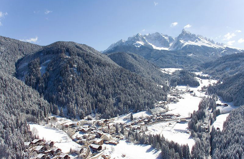 Nova Ponente in Italy - a view of a snowy village in the mountains.
