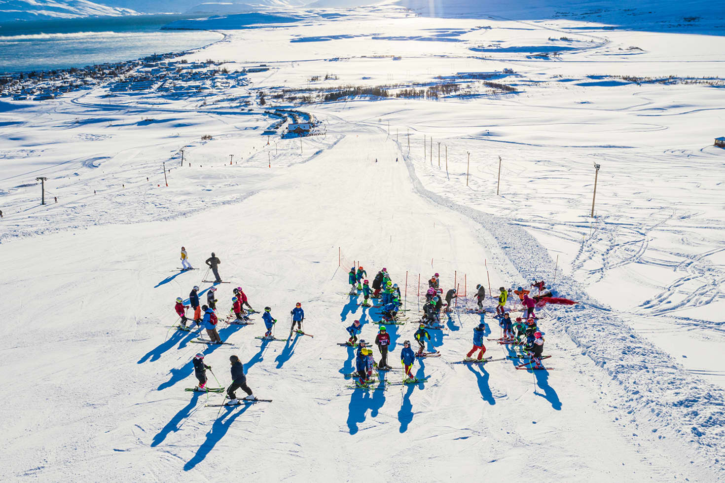 Húsavík in Iceland - a group of people skiing down a snowy hill.