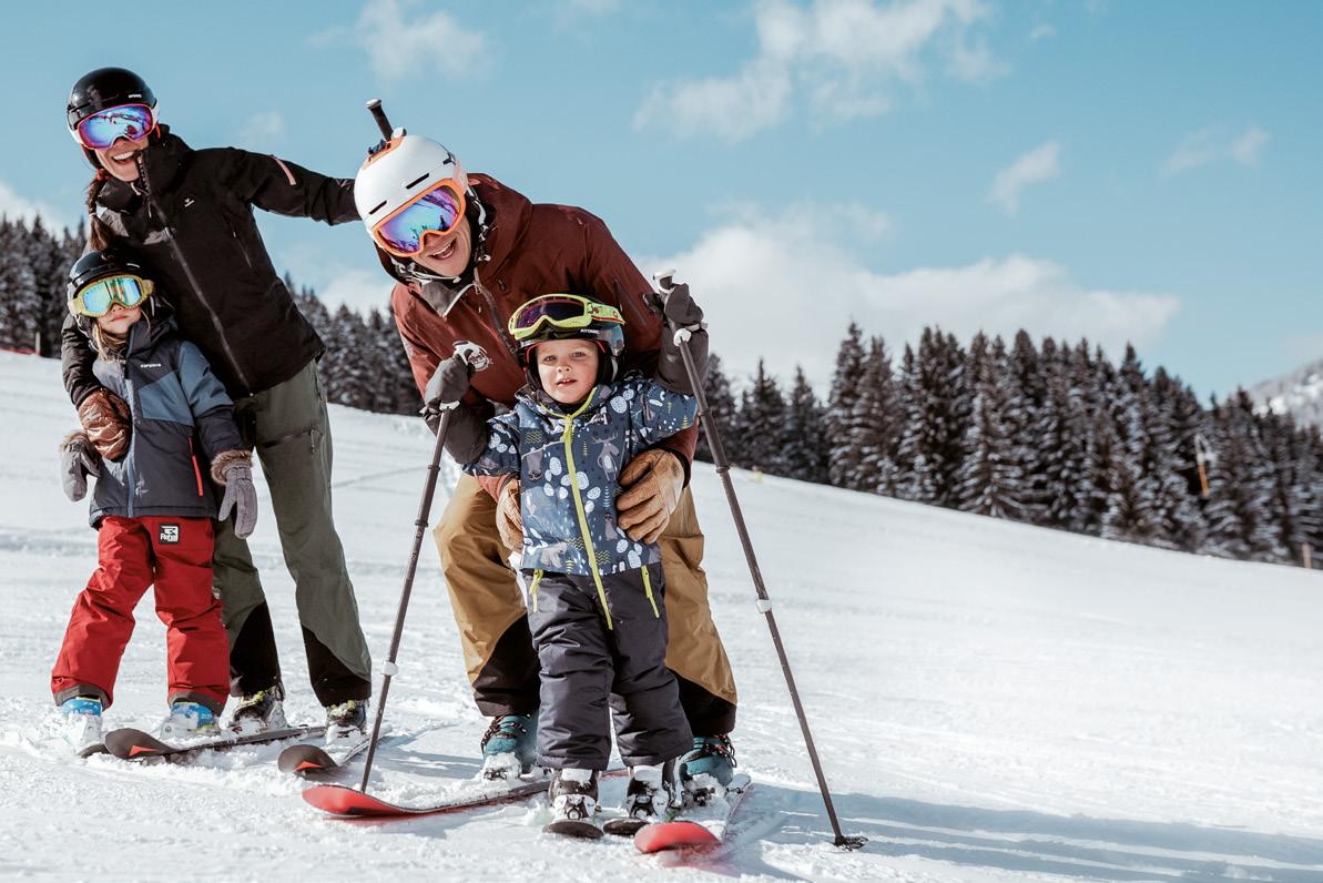 Liebenau in Austria - a family skiing on the slopes of a mountain.