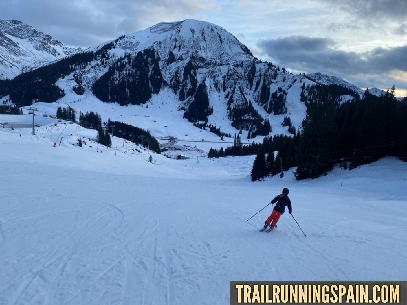 Skiarena Berwang in Austria - a person skiing down a snow covered mountain.