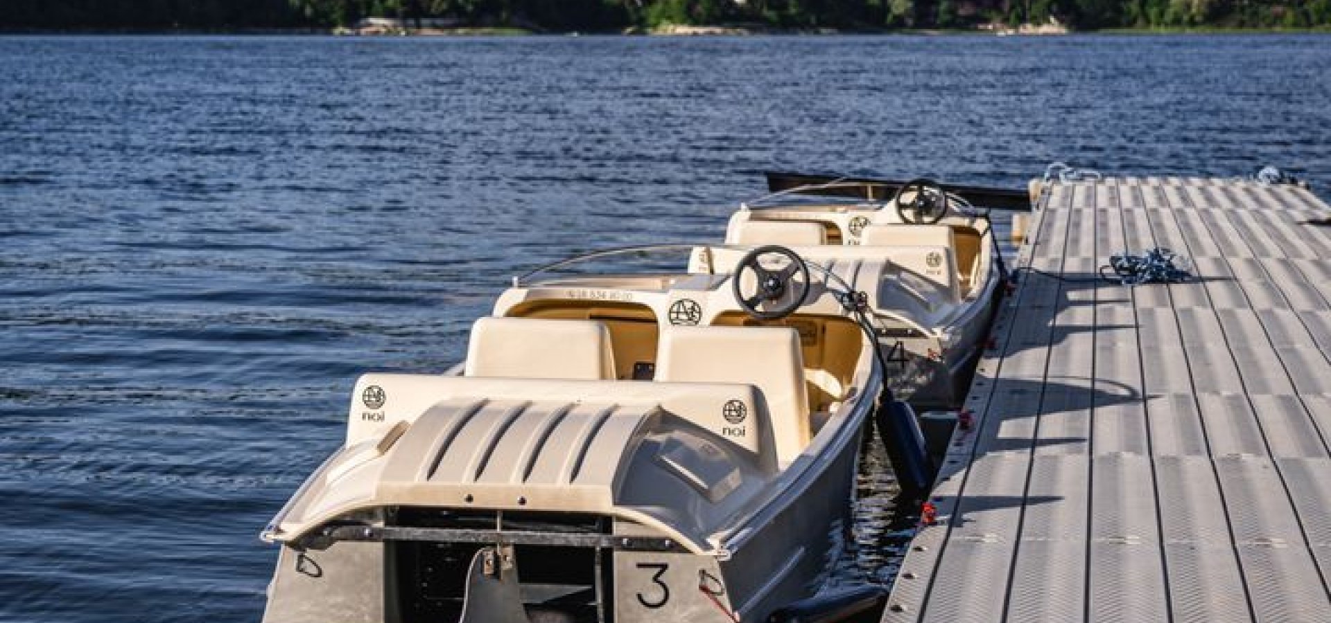 Cieniawa in Poland - a boat parked on a dock next to a lake.