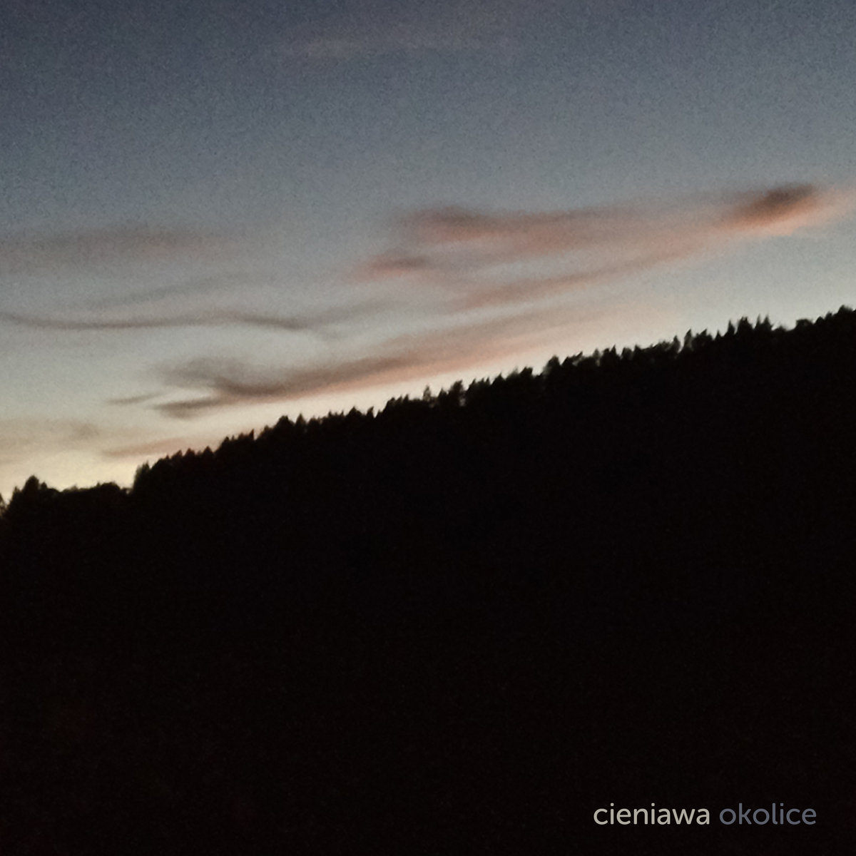 Cieniawa in Poland - the sun is setting over the mountains and trees.