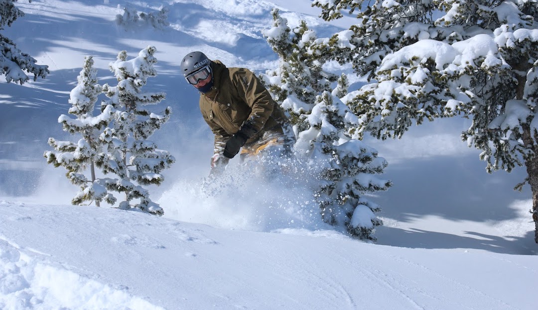Red Lodge Mountain in USA - a man riding a snowboard down a snow covered slope.