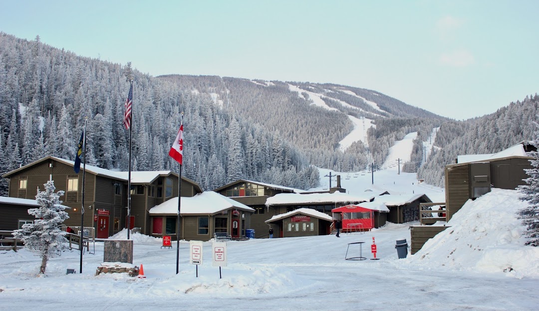 Red Lodge Mountain in USA: a ski resort covered in snow with a mountain in the background.
