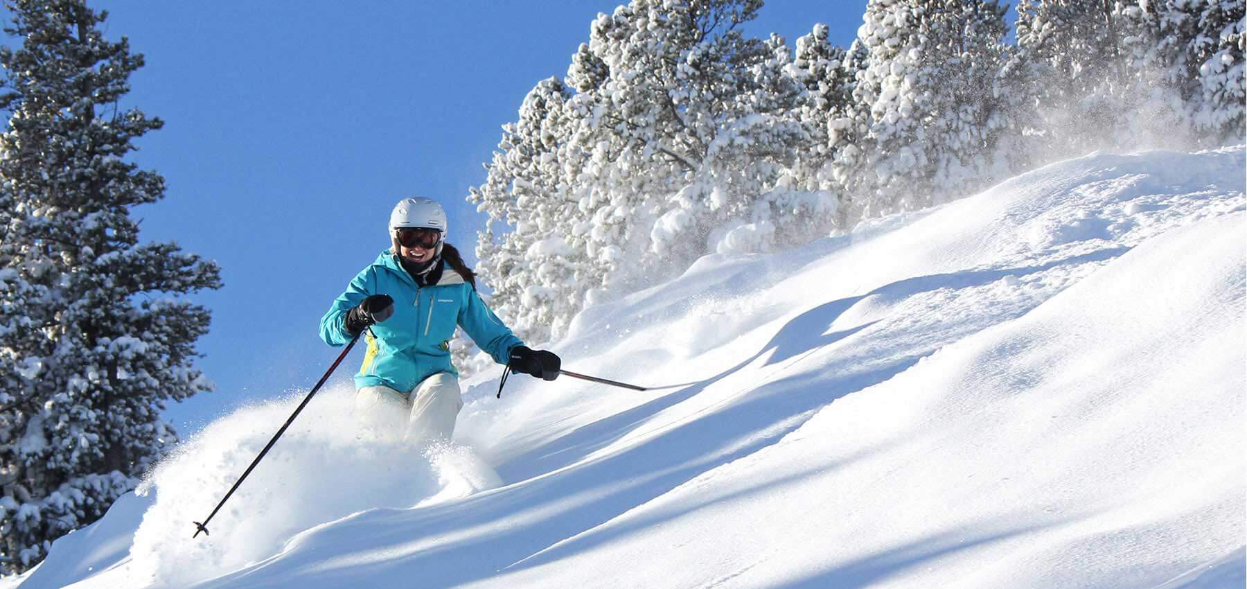 Red Lodge Mountain in USA - a person skiing down a snow covered hill.