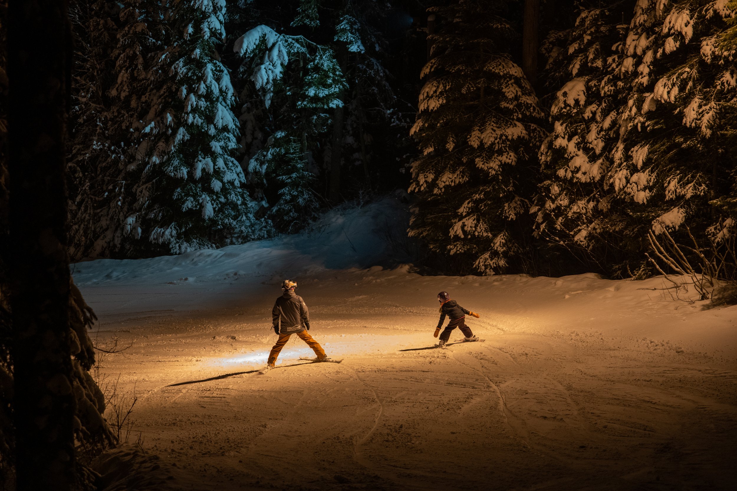 Winter sports scene at Hart Highlands in Northern British Columbia, Canada with people enjoying skiing amidst stunning snow-covered landscapes.