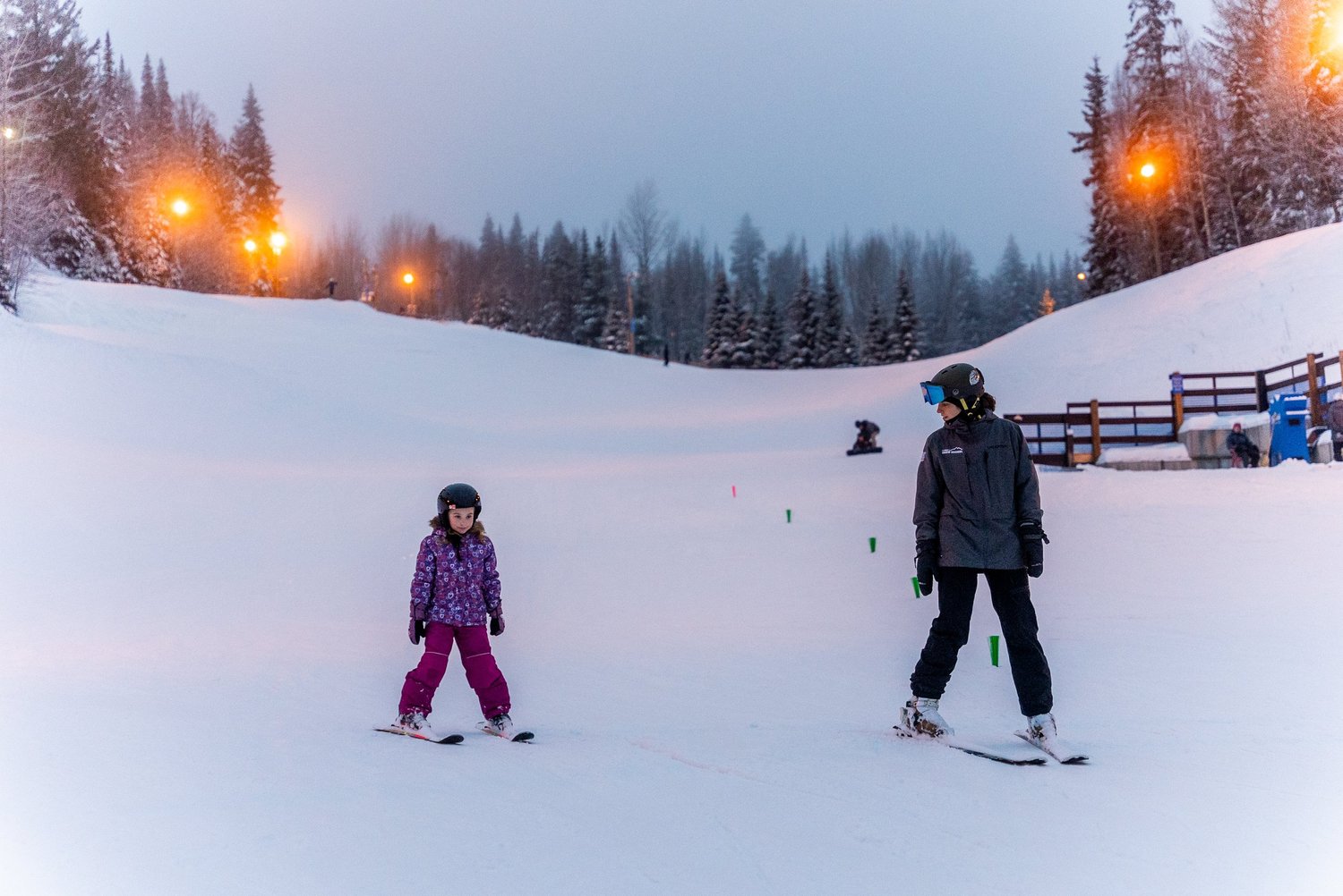 Winter scene at Hart Highlands in Prince George, Northern British Columbia featuring a family enjoying skiing activities demonstrating the vibrant winter sports that the region offers.