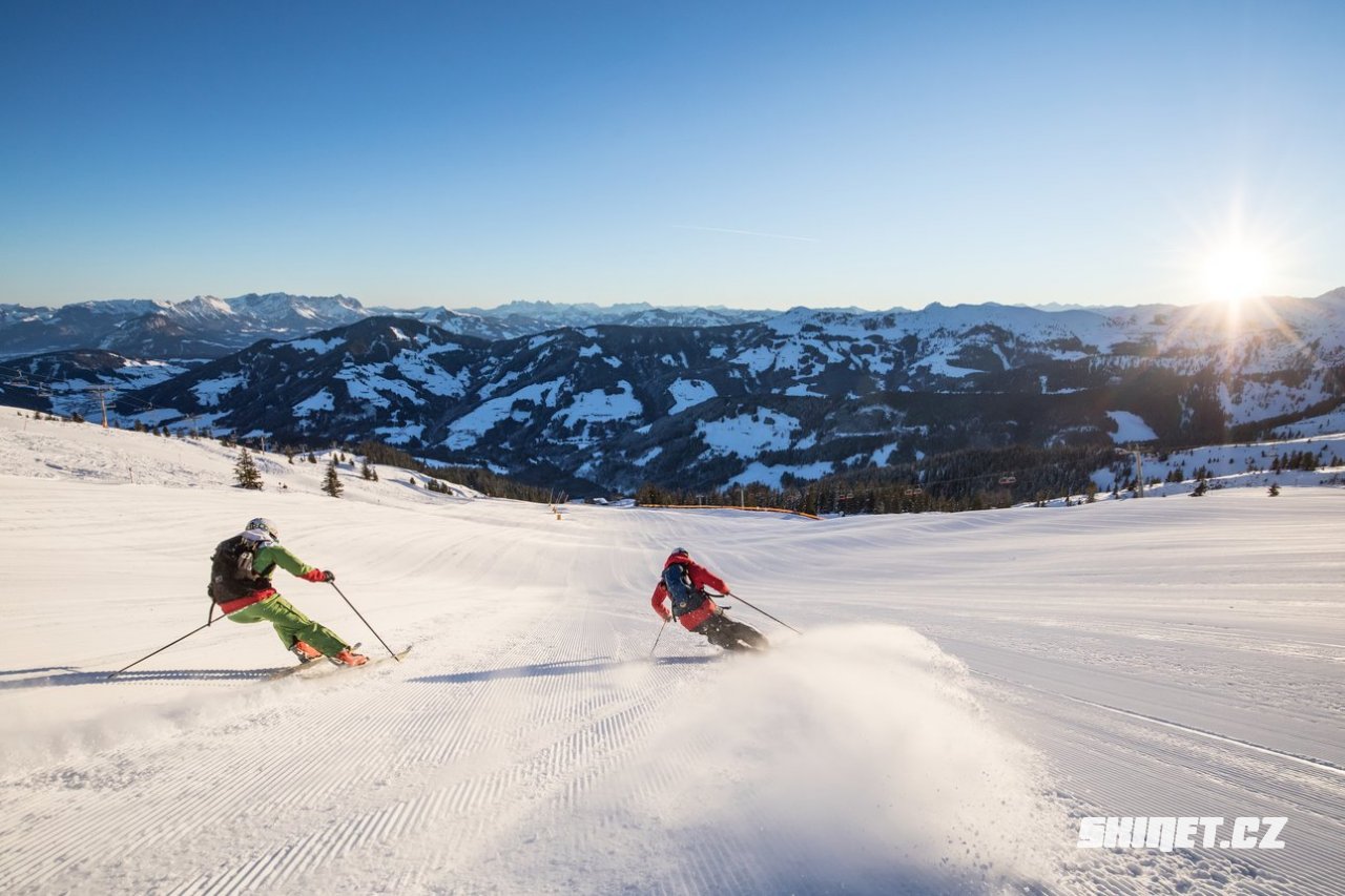 Böglerlift – Alpbach in Austria - two people skiing down a snowy slope in the mountains.