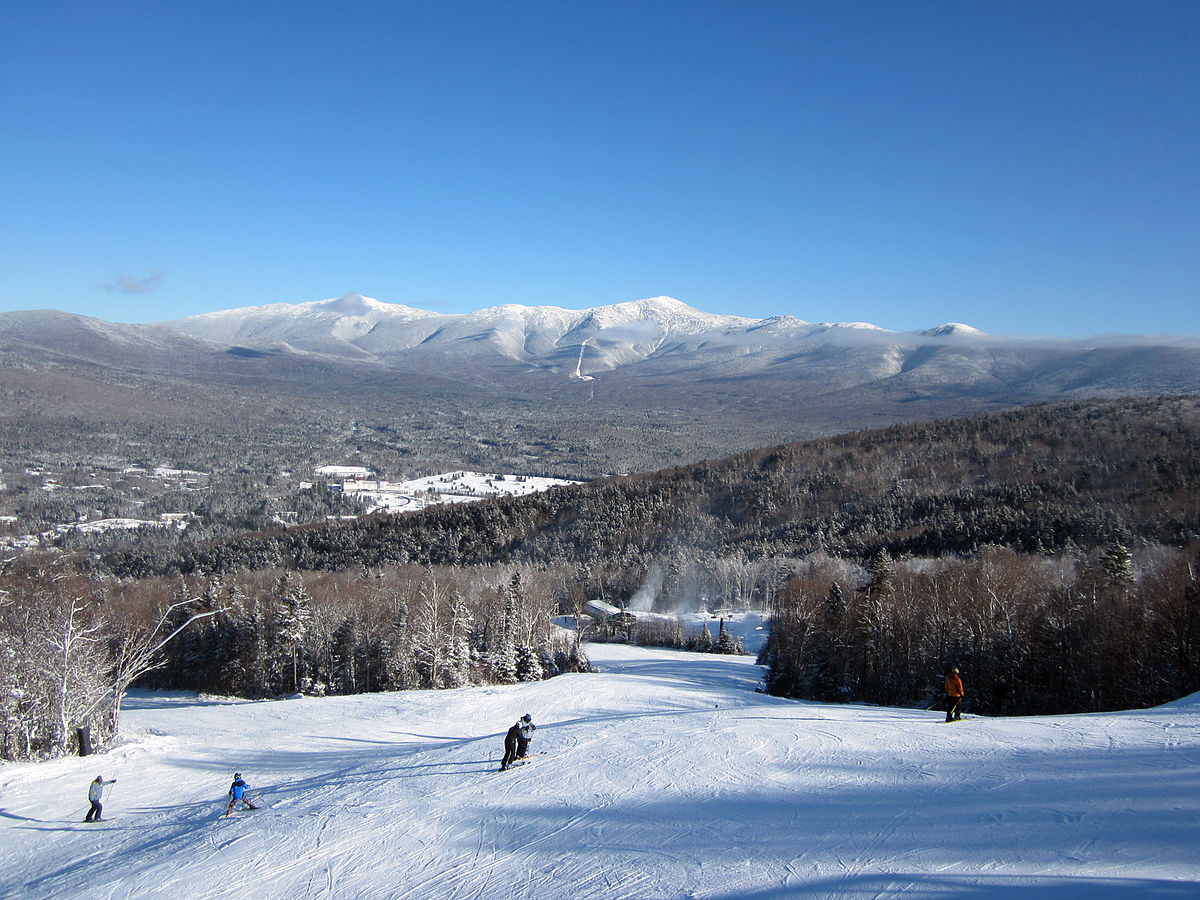 Bretton Woods in USA - a group of people skiing down a mountain.