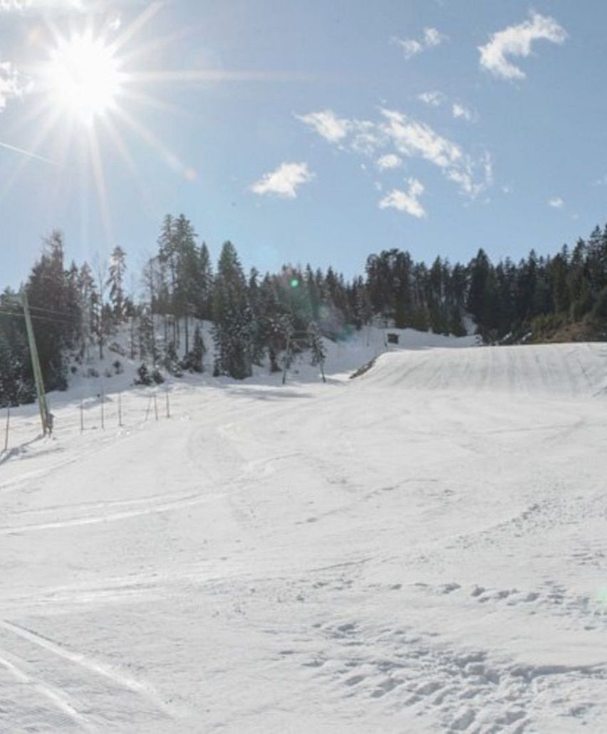 Neuleutasch in Austria - a snowboarder is going down the hill.
