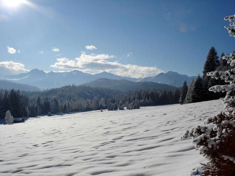 Neuleutasch in Austria - a snow covered field in the mountains.
