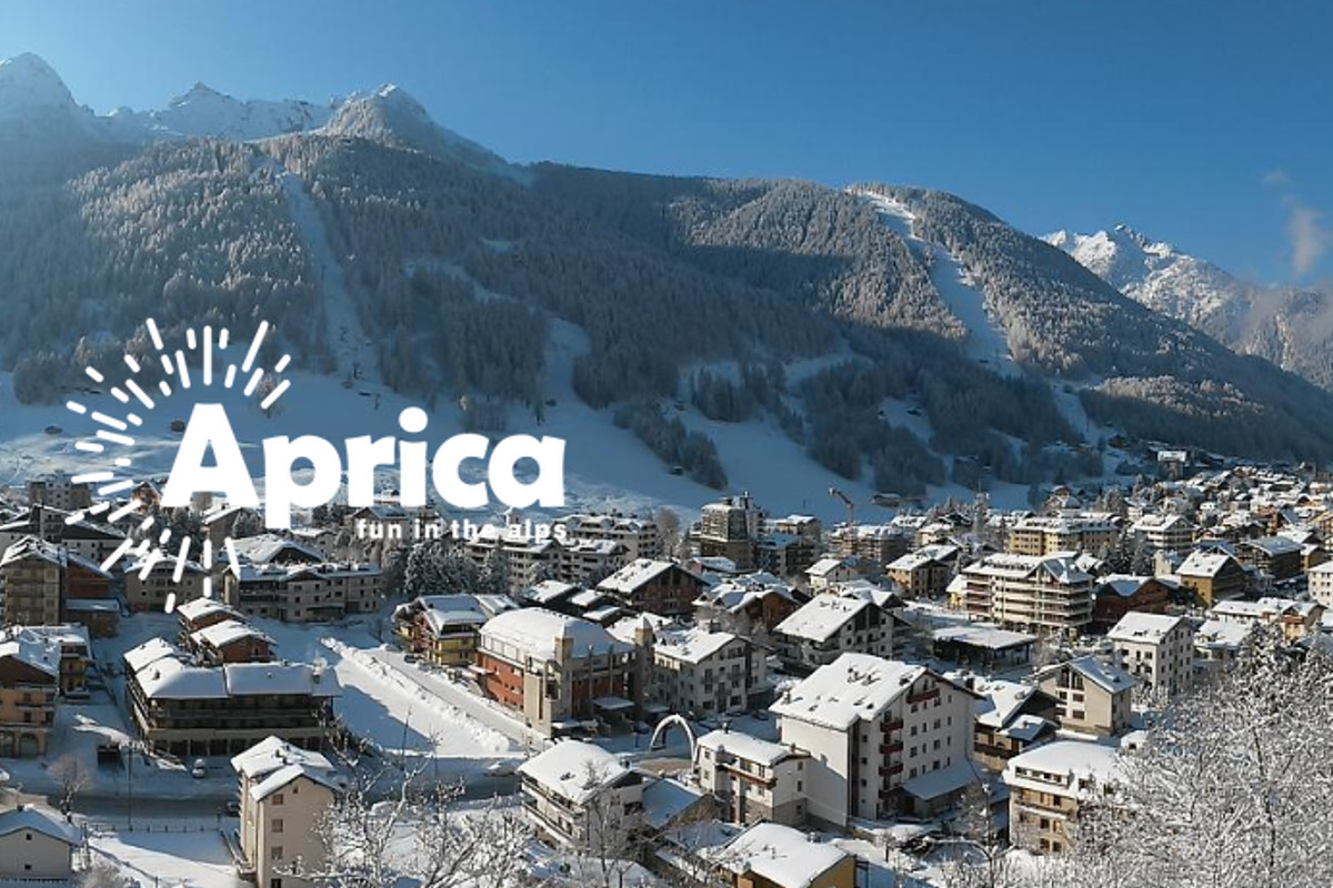 Aprica in Italy - an image of a snowy town with mountains in the background.