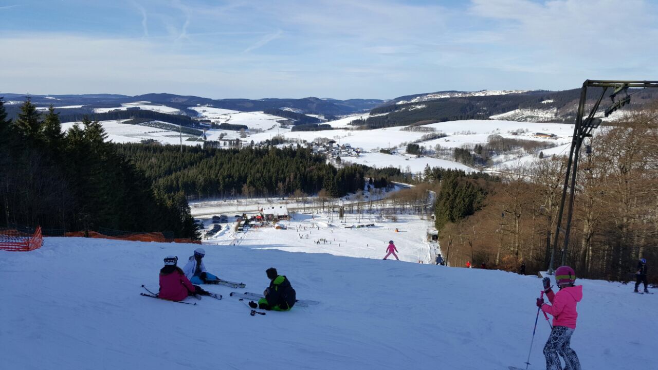 Giller – Hilchenbach-Lützel in Germany - a group of people skiing down a snowy slope.