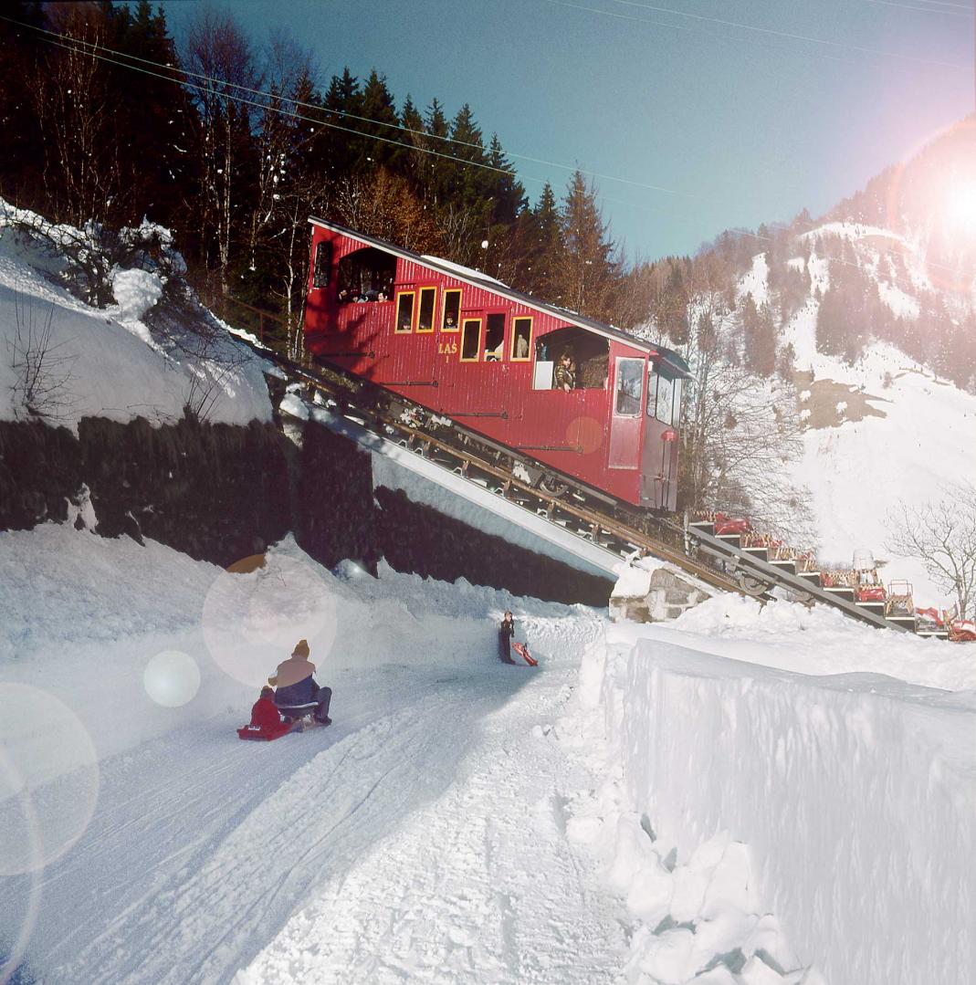 Les Prévondes in Switzerland - a red train traveling down a snowy hill.